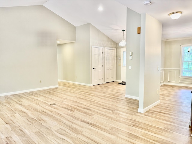 18 Patricia Ln, Saint George, ME 04859 - unfurnished living room with light wood-type flooring, a chandelier, high vaulted ceiling, and baseboards