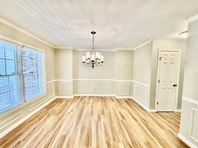 18 Patricia Ln, Saint George, ME 04859 - unfurnished dining area featuring a chandelier, wood finished floors, crown molding, a decorative wall, and a wainscoted wall