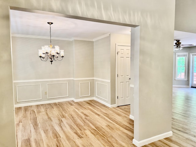 18 Patricia Ln, Saint George, ME 04859 - unfurnished dining area featuring light wood-style flooring, a chandelier, ornamental molding, ceiling fan, and a decorative wall