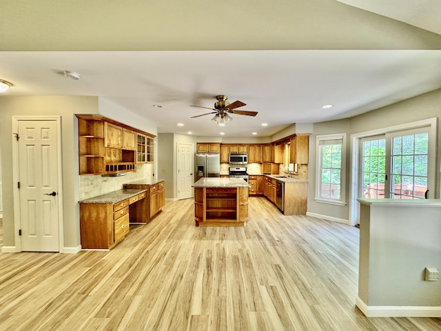 18 Patricia Ln, Saint George, ME 04859 - kitchen with open shelves, stainless steel appliances, brown cabinetry, light wood-style floors, and baseboards