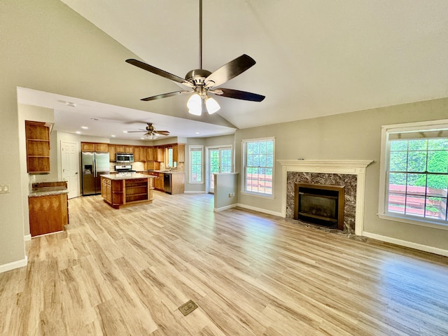 18 Patricia Ln, Saint George, ME 04859 - unfurnished living room featuring baseboards, light wood-style flooring, a premium fireplace, a ceiling fan, and recessed lighting