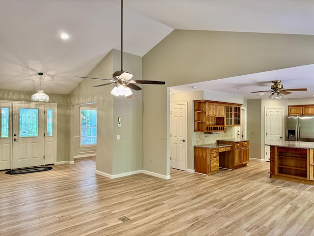 18 Patricia Ln, Saint George, ME 04859 - kitchen with open shelves, stainless steel refrigerator with ice dispenser, brown cabinets, and high vaulted ceiling
