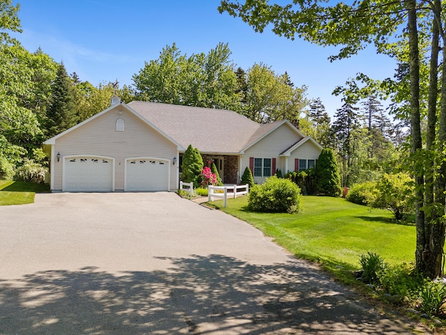 18 Patricia Ln, Saint George, ME 04859 - single story home with concrete driveway, a front lawn, a garage, and a shingled roof