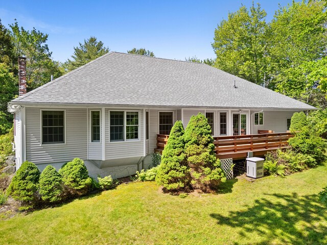 18 Patricia Ln, Saint George, ME 04859 - rear view of property featuring a chimney, a shingled roof, a lawn, and a wooden deck