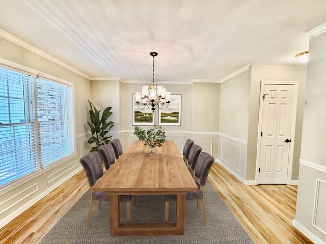 18 Patricia Ln, Saint George, ME 04859 - dining space with a chandelier, light wood-style floors, a decorative wall, crown molding, and a wainscoted wall