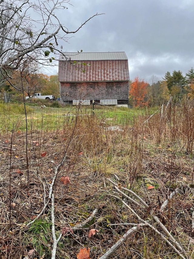 exterior space featuring metal roof, an outdoor structure, and a barn