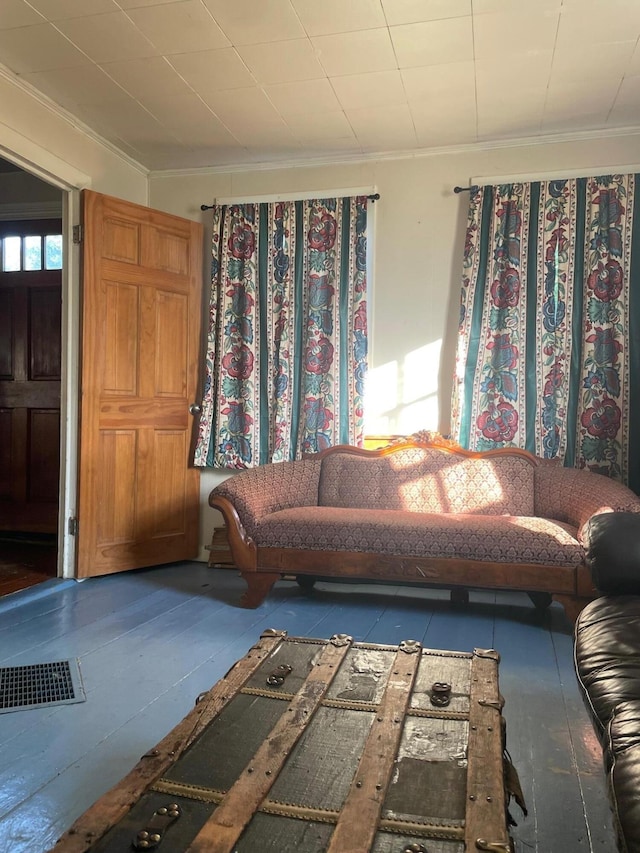 living room featuring ornamental molding and visible vents