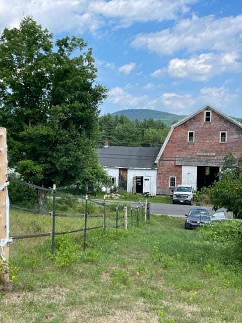 view of yard featuring fence and a mountain view