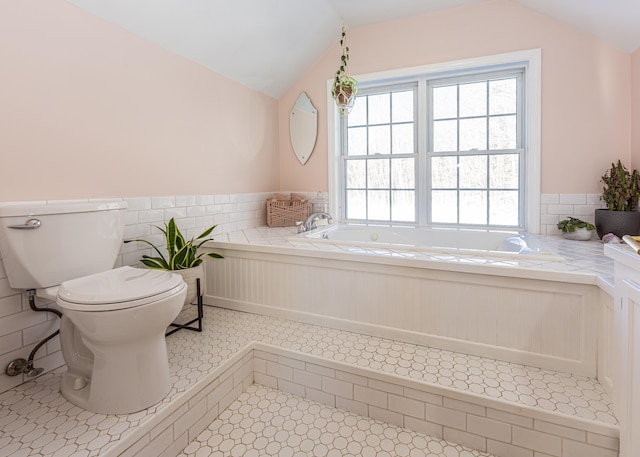 bathroom with lofted ceiling, toilet, tile patterned flooring, and tile walls