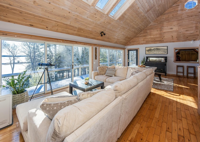 living room with hardwood / wood-style floors, a skylight, wooden ceiling, and high vaulted ceiling