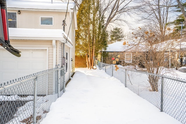 yard covered in snow with a garage