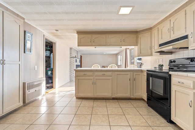 kitchen with light tile patterned flooring, decorative backsplash, black range with electric cooktop, and heating unit