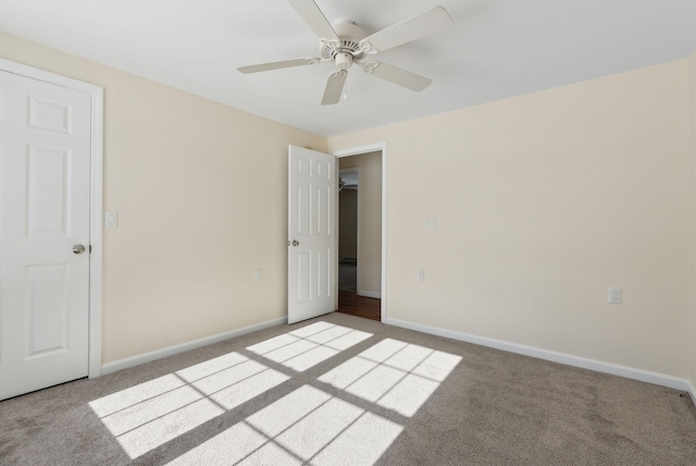 unfurnished bedroom featuring ceiling fan and light carpet