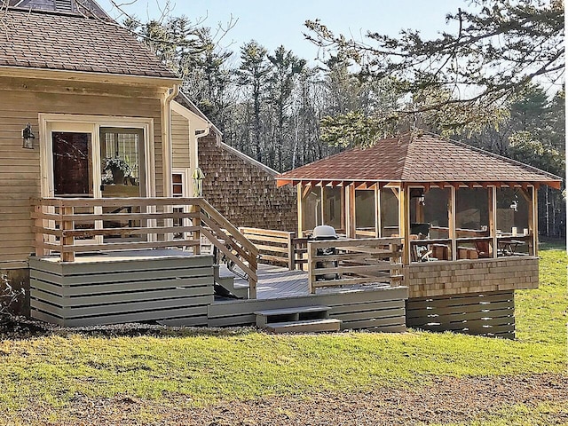 wooden deck with a yard and a sunroom