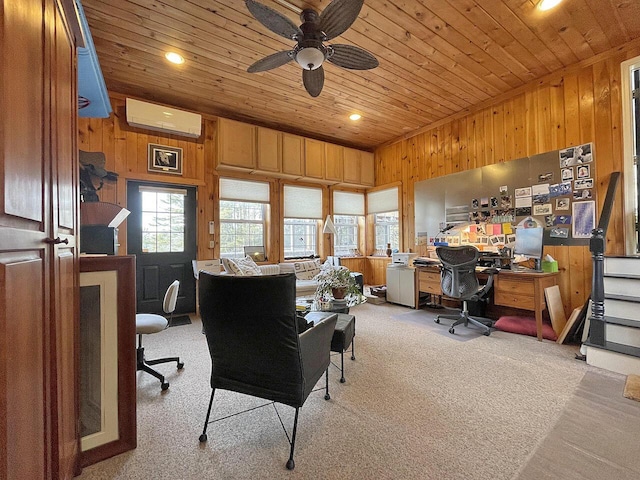 carpeted office with wood ceiling, a wall unit AC, ceiling fan, and wood walls