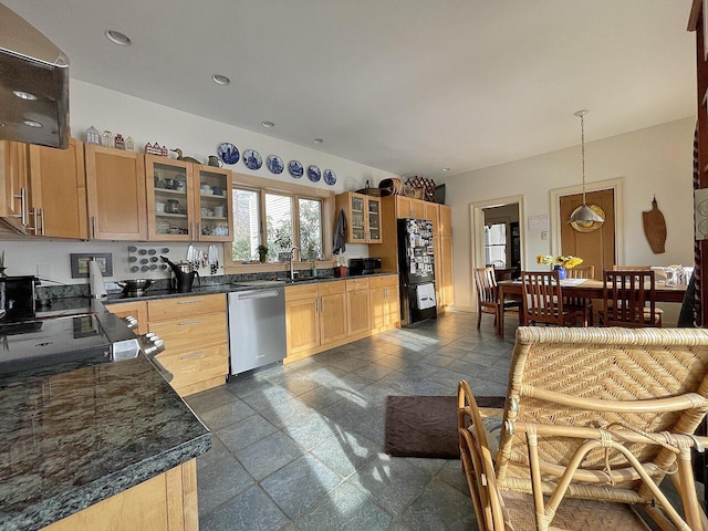 kitchen with black refrigerator, pendant lighting, dishwasher, sink, and light brown cabinets