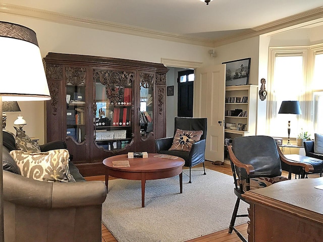 living room with light hardwood / wood-style flooring and ornamental molding