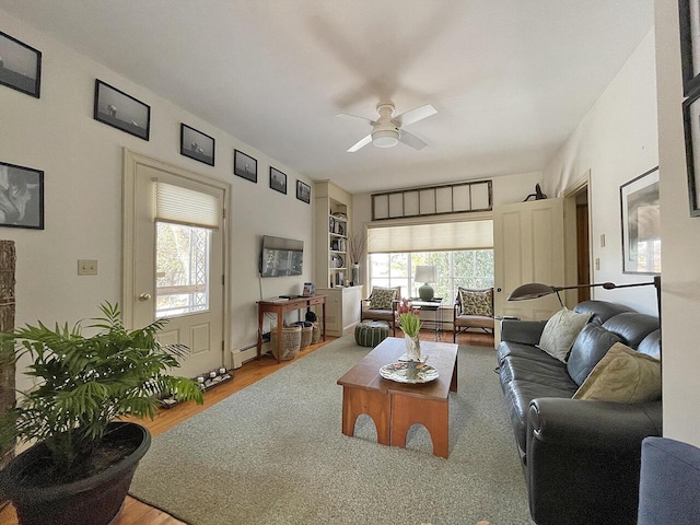 living room with a baseboard heating unit, hardwood / wood-style flooring, plenty of natural light, and ceiling fan