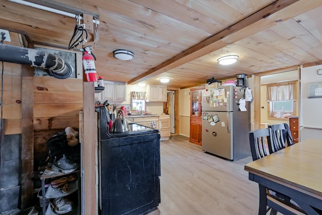 kitchen featuring stainless steel refrigerator, beamed ceiling, sink, wooden ceiling, and light wood-type flooring