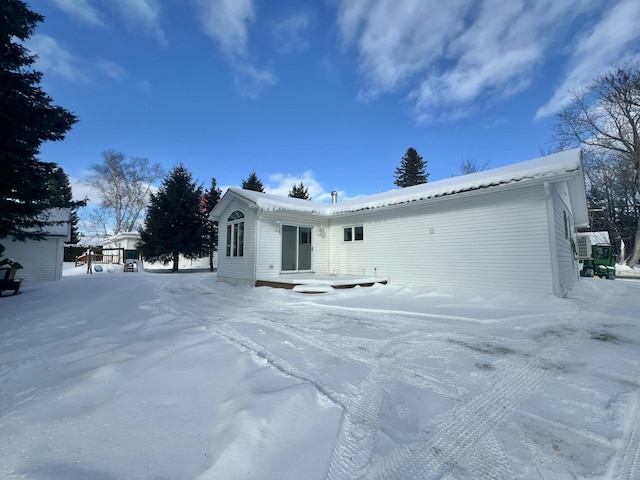 view of snow covered rear of property