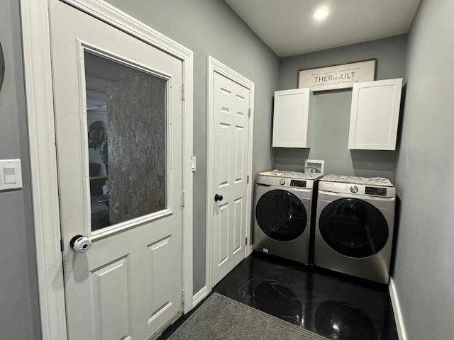 clothes washing area with cabinets and washer and dryer