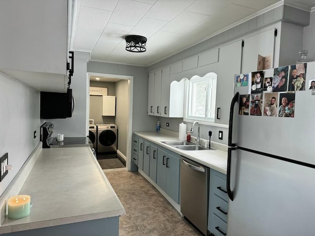 kitchen with sink, crown molding, dishwasher, refrigerator, and independent washer and dryer