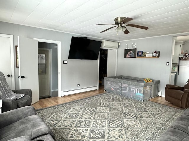 living room featuring hardwood / wood-style floors, a baseboard radiator, an AC wall unit, and ceiling fan