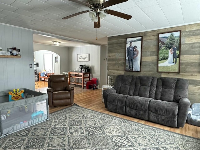 living room with ceiling fan and wood-type flooring