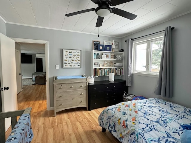 bedroom with crown molding, ceiling fan, and light hardwood / wood-style floors