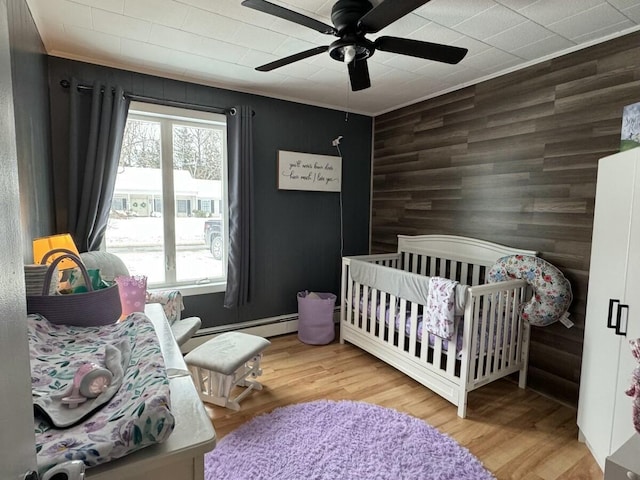 bedroom featuring multiple windows, light hardwood / wood-style flooring, and ceiling fan