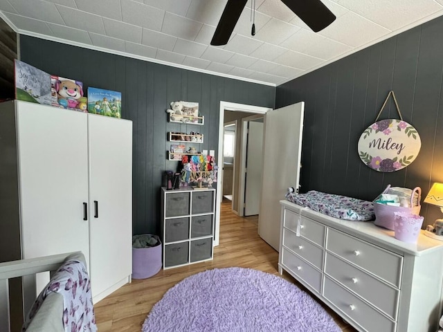 bedroom featuring crown molding, ceiling fan, and light hardwood / wood-style flooring