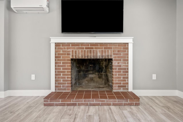 details with hardwood / wood-style flooring and a wall unit AC