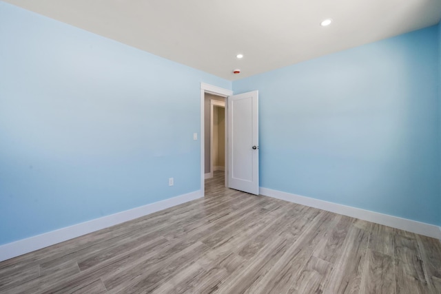 empty room with light hardwood / wood-style floors