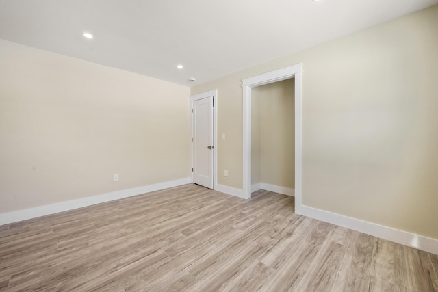 spare room with light hardwood / wood-style flooring