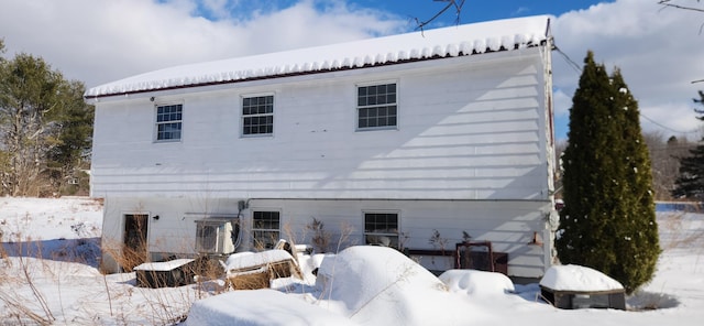 view of snow covered rear of property