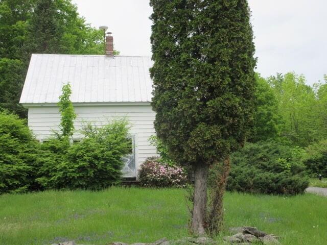 236 Frenchs Mill Rd, Sangerville, ME 04479 - view of side of property with a chimney and metal roof