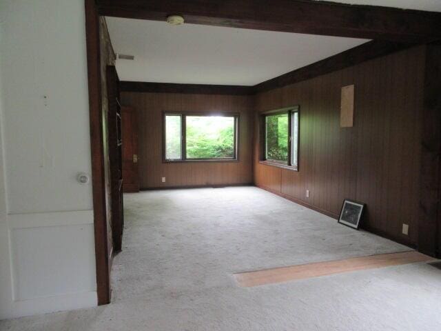 236 Frenchs Mill Rd, Sangerville, ME 04479 - spare room with light colored carpet, beamed ceiling, and wood walls