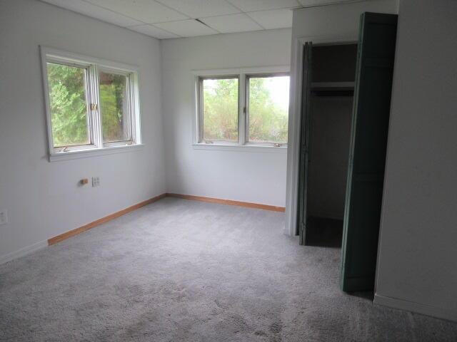 236 Frenchs Mill Rd, Sangerville, ME 04479 - unfurnished bedroom featuring carpet, a paneled ceiling, and baseboards