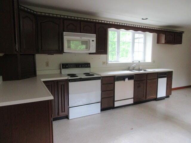 236 Frenchs Mill Rd, Sangerville, ME 04479 - kitchen featuring white appliances, light countertops, a sink, light floors, and baseboards