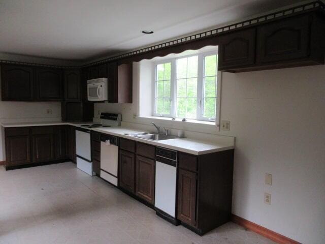 236 Frenchs Mill Rd, Sangerville, ME 04479 - kitchen featuring white appliances, a sink, light countertops, and baseboards