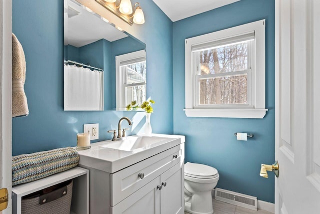 bathroom featuring toilet and vanity