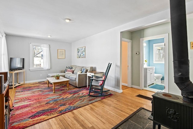 living room featuring hardwood / wood-style floors and a wood stove