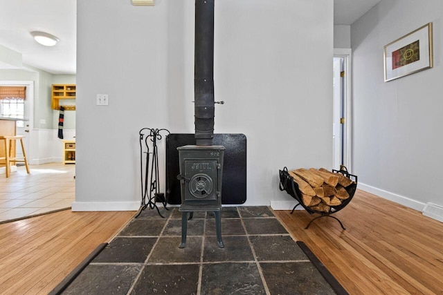 details with hardwood / wood-style flooring and a wood stove