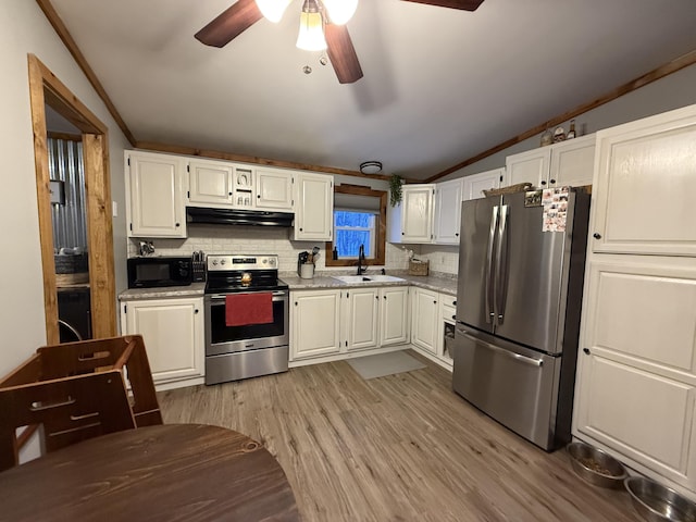 kitchen with white cabinetry, lofted ceiling, sink, light hardwood / wood-style floors, and stainless steel appliances