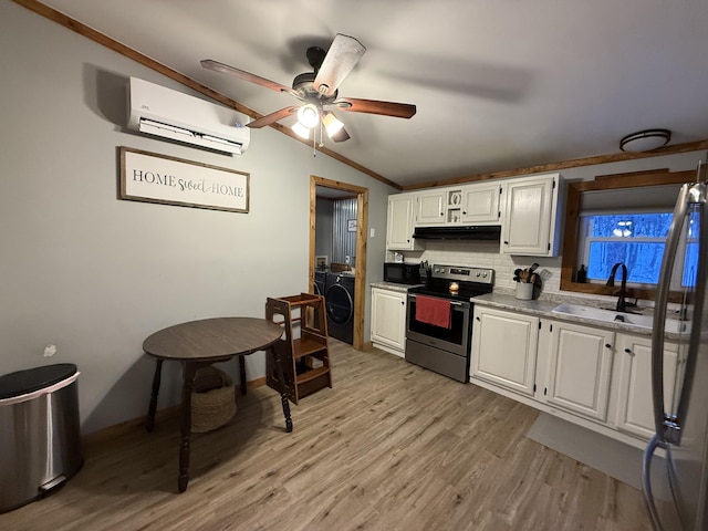 kitchen featuring white cabinetry, lofted ceiling, stainless steel appliances, and sink