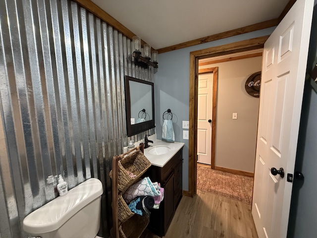 bathroom with vanity, toilet, and hardwood / wood-style floors