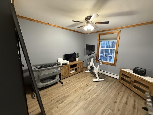 exercise room with light hardwood / wood-style flooring, ornamental molding, ceiling fan, and baseboard heating