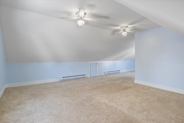 additional living space featuring a baseboard heating unit, vaulted ceiling, light colored carpet, and ceiling fan