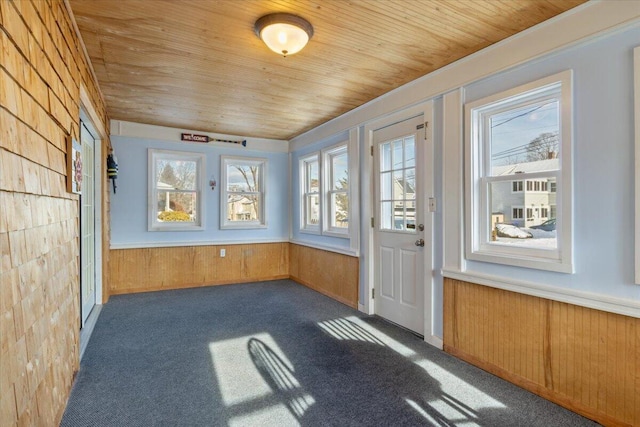 unfurnished sunroom featuring wooden ceiling and a healthy amount of sunlight