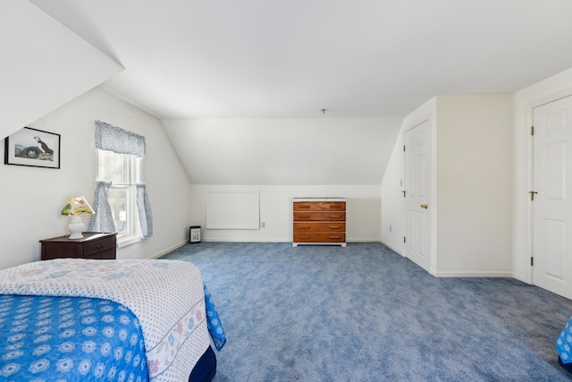 carpeted bedroom with vaulted ceiling